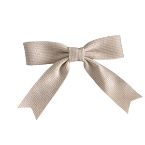 Minimalist beige ribbed fabric bow hair clip with elegant long swallowtail streamers