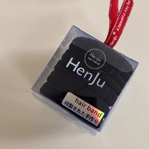 Close-up of black high-elastic seamless hair bands in a premium gift box with red ribbon
