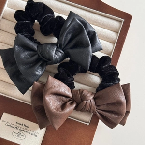 Elegant leather double bow scrunchies in black and brown velvet for stylish hairstyles