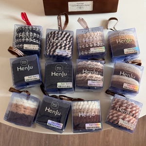 Close-up of 12-piece elastic hair tie set in a gift box with earth-tone neutral colors
