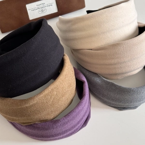 Detailed view of padded wide-brim headbands in various elegant matte velvet colors