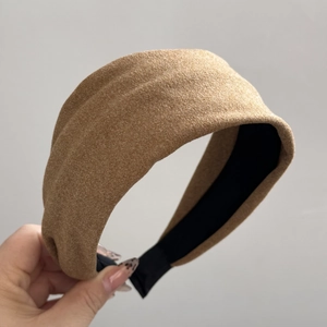 Close-up of wide velvet texture twisted headband in earthy brown with soft fabric