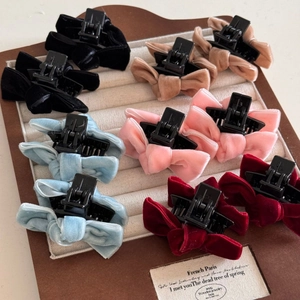 Macro shot of colorful velvet bow hair clips in five elegant shades for styling