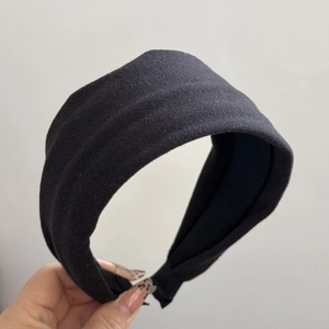 Close-up of wide black solid color vintage headband in high-quality textured fabric