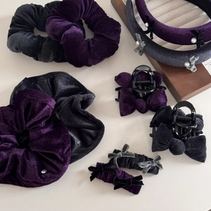 Close-up of vintage purple velvet scrunchies and headbands with pearl details