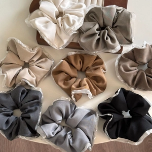Detail of multi-colored chiffon scrunchies with white mesh and delicate pearl edges