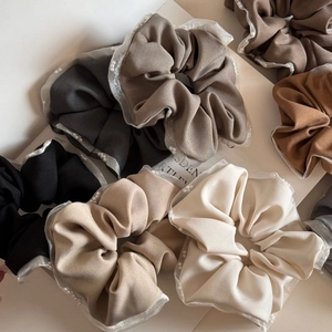 Elegant pearl-trimmed scrunchies in neutral earth tones with sheer mesh edge details