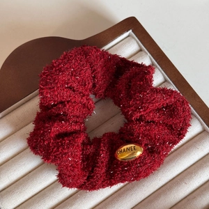 Dark red plush hair scrunchie with silver glitter and a gold metal brand tag