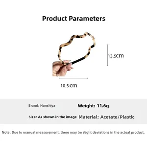 Detailed view of brown tortoiseshell acetate wavy headband with size dimensions in centimeters