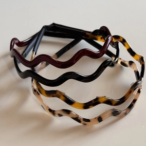 Set of four wave shaped acetate hair hoops in black red and tortoise patterns