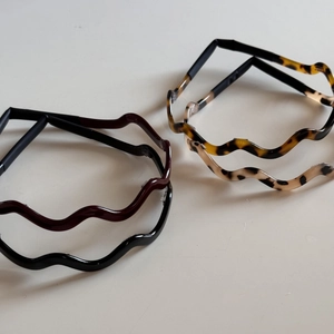Set of four wavy acetate hairbands in black, dark red, and tortoise shell patterns