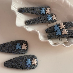 Detail view of 6-piece handmade gray knit teardrop hair clips with cute 3D bear ornaments
