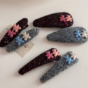 Detail showing six tweed fabric hair clips with cute resin bear charms on white background