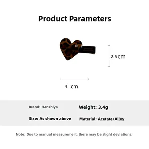 Macro view of leopard print heart hair clip showing dimensions 4cm x 2.5cm and texture