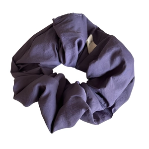 Purple oversized scrunchie with pleated texture and white Hand Made tag on white background