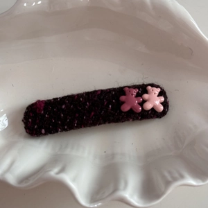 Detail of tweed fabric hair clip with two cute resin bear figures on shell plate