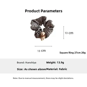Detail view of plaid bear hair scrunchie with 13cm diameter and 27cm circumference size details