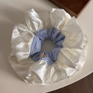 Oversized satin hair scrunchie with blue stripes and handmade label for elegant styling