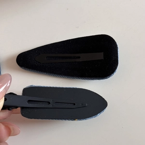 Detailed back view of denim fabric hair clips with non-slip black felt padding inserts