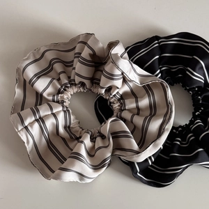 Detail of striped chiffon scrunchies showing pleated texture and fabric quality