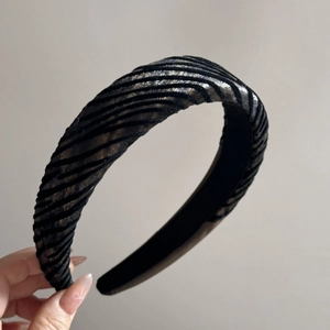 Macro shot of a zebra striped velvet padded headband with metallic silver highlights