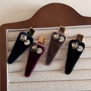 Detail of velvet hair clips with square crystals and engraved silver charms in four colors