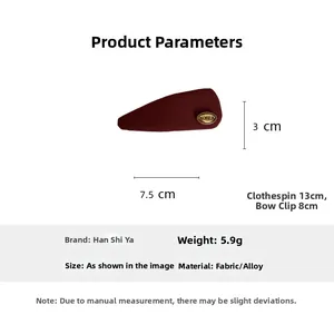 Detail view of red fabric hair clip with Korea gold emblem showing product dimensions
