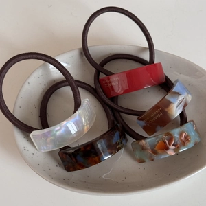 Lot de cinq chouchous en acétate aux motifs géométriques et détails dorés chics