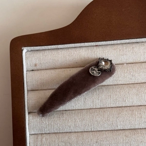 Detailed view of vintage velvet hair clip with square rhinestone and embossed silver plate