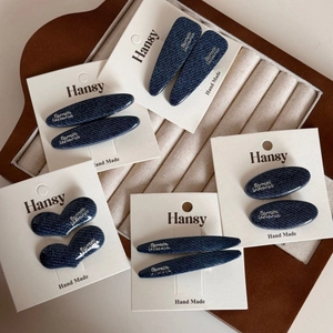 Denim blue fabric hair clip set with white letter labels in multiple stylish shapes