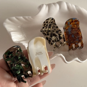 Detailed set of four premium acetate hair claws with gold Barrette La France printing