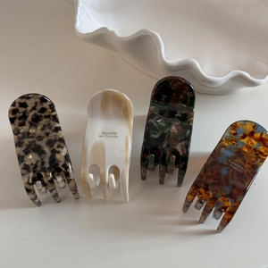 Detail of elegant acetate hair claws featuring tortoiseshell, marble and ivory patterns