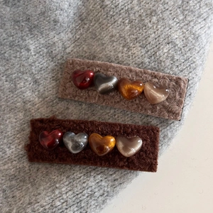Detailed view of plush heart hair clips set in brown faux fur for autumn winter