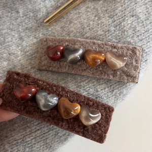 Detailed view of plush coffee brown BB hair clips with 3D amber heart beads for winter