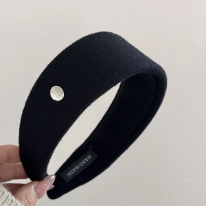 Detail of handmade headband with believe in yourself metal buckle and wool texture