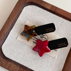 Detailed close-up of handmade star hair clips with golden France branding on the side