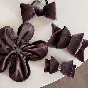 Detailed set of brown velvet hair accessories including scrunchies and bow hair clips