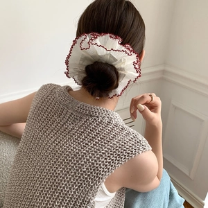 Oversized white lace scrunchie with red wavy edges for high buns and elegant hair styling