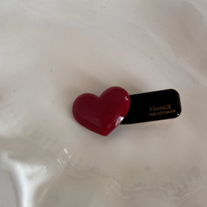 Detail of red heart acetate hair clip with FRANCE Handmade text on black base