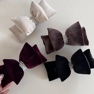Set of four velvet bow hair clips in beige, brown, burgundy, and black with pearls