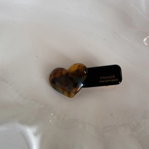 Detail view of heart-shaped tortoiseshell hair clip with FRANCE Handmade inscription