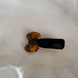 Detail of a handmade tortoise shell pattern hair clip with gold France logo