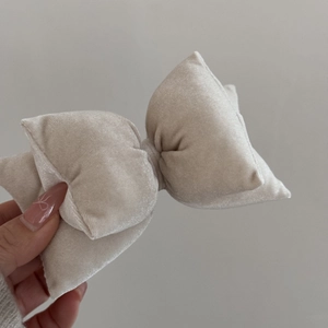 Close-up of beige velvet oversized bow hair clip with soft texture and premium handwork