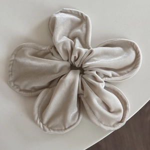 Detailed top view of champagne velvet floral hair scrunchie with soft padded texture