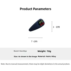 Detail view of a 7x3cm dark blue denim cherry hair clip with dimensions and 7.8g weight