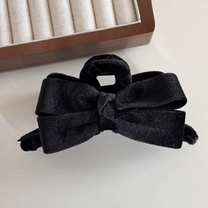 Detailed view of the elegant black velvet bow hair claw clip showing premium soft texture