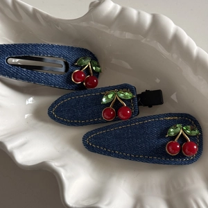 Three-piece denim hair clip set with red crystal cherry embellishments and yellow stitching