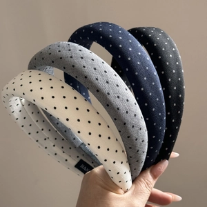 Set of four padded knit headbands with small polka dots in white, grey, blue and black