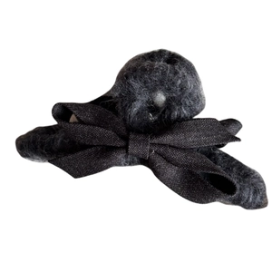 Plush black bow hair claw clip with fuzzy faux lamb wool texture for elegant hair styling