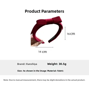 Detail of red velvet bow headband showing 30.5g weight and 14cm x 16cm dimensions